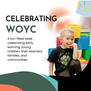 a little boy sits in front of blocks chewing on his fingernail wearing a graphic black t shirt and black sweatpants